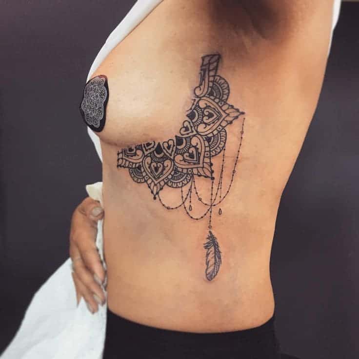 mandela and feather boob tattoo, feather and mandela boob tattoo, beautiful feather side boob tattoo, feather side boob tattoo, feather breast tattoo, feather boob tattoo